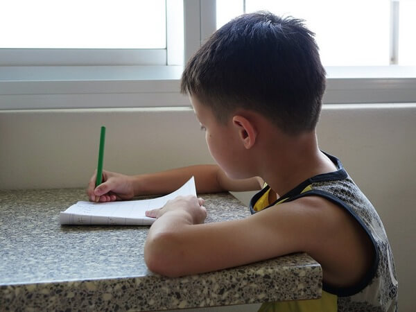 boy at same time and place to do homework